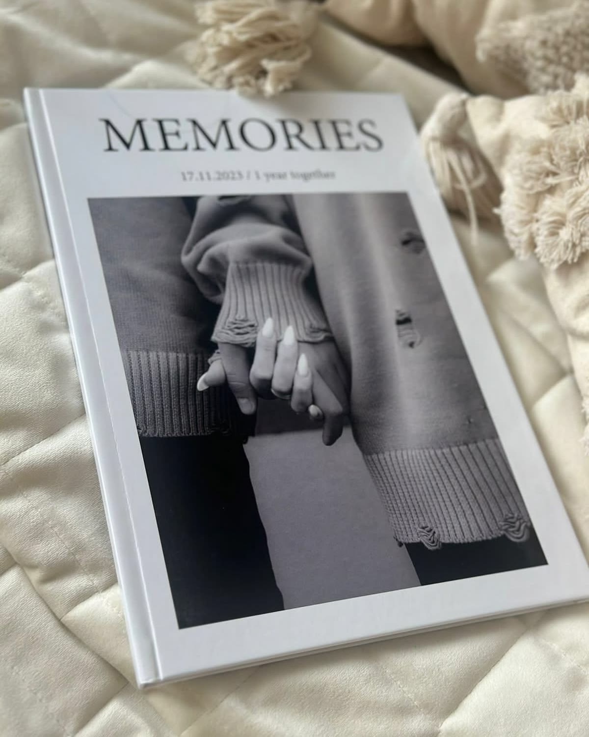 Closed white hardcover photo book titled Memories with a black-and-white photograph on the cover