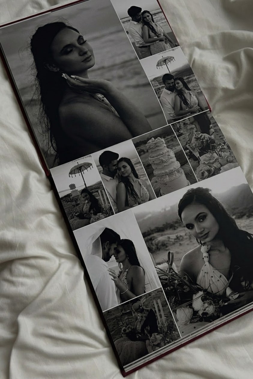 Open softcover photo book showing a collage of black-and-white wedding photographs