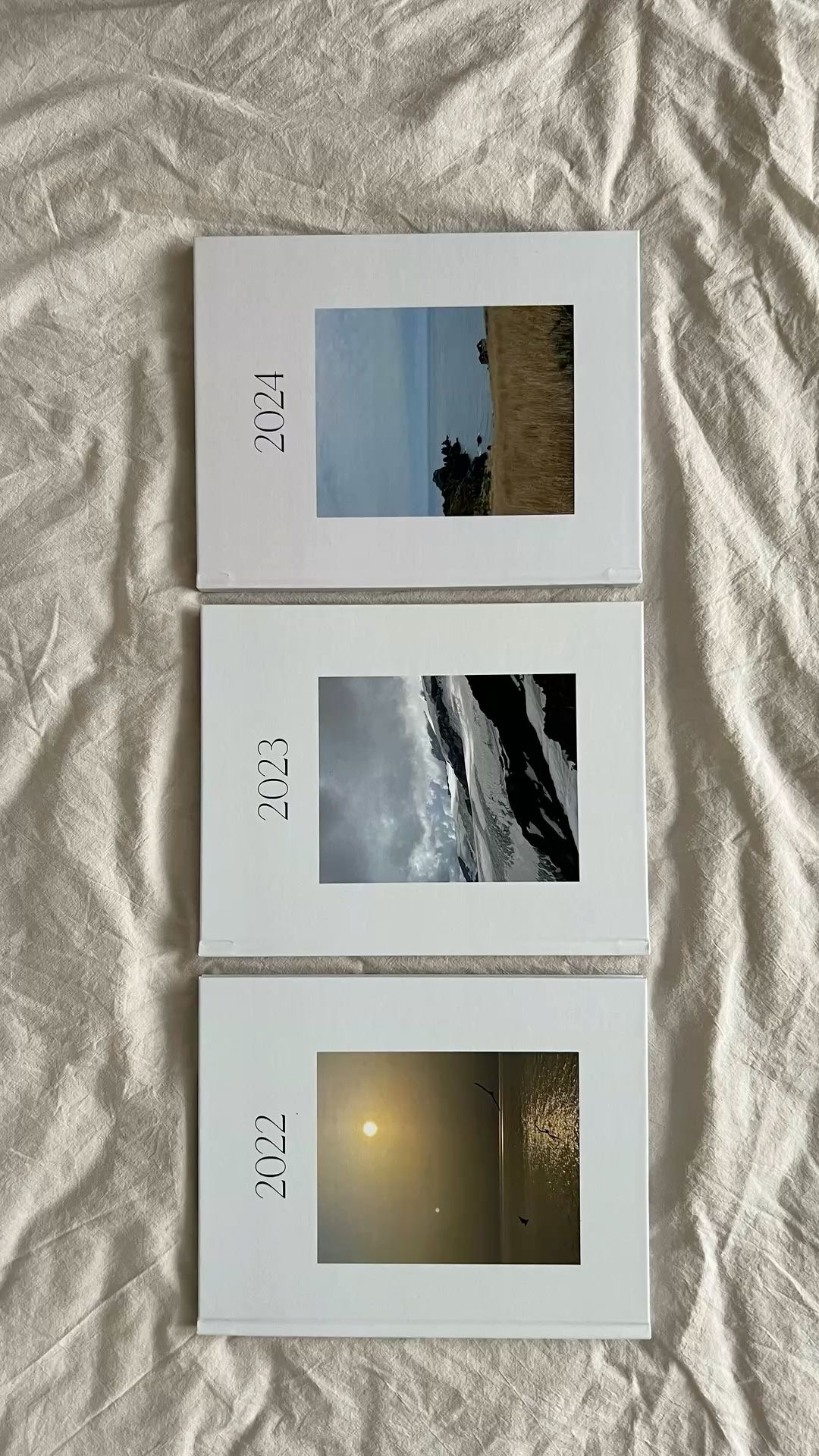 Three yearly photo books stacked
